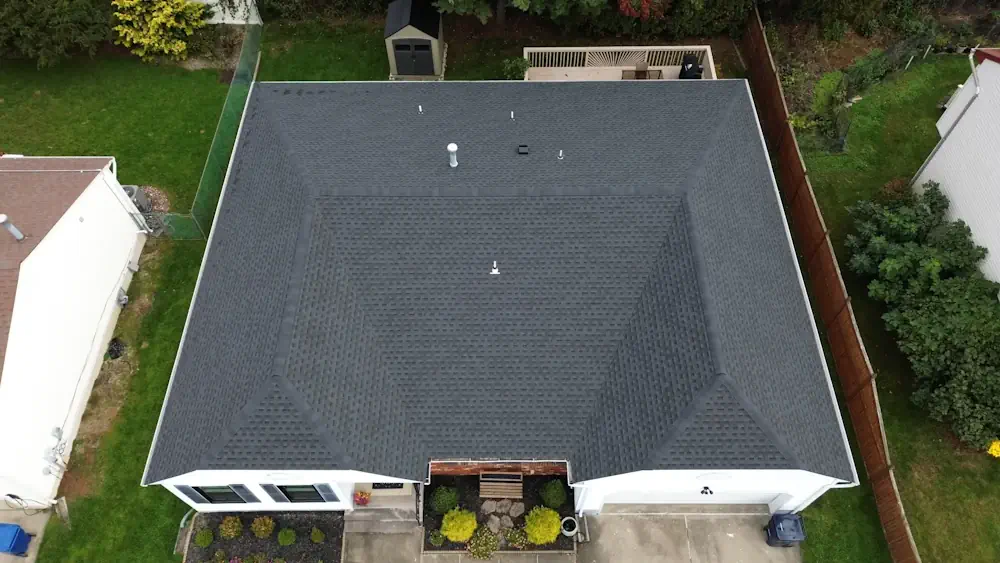 Top-down aerial view of professional black roof installation by Double D Construction in New Jersey